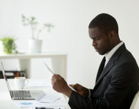 Serious,African,American,Ceo,Attentively,Reading,Received,Letter,,Business,Person