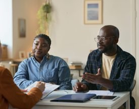 Portrait,Of,Adult,African,American,Couple,Talking,To,Insurance,Agent